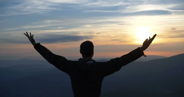 Man on the top of the world praying to god at sunset Royalty Free Stock Photos