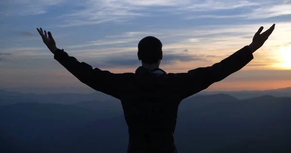 Man on the top of the world at sunset spread his arms. Stock Image