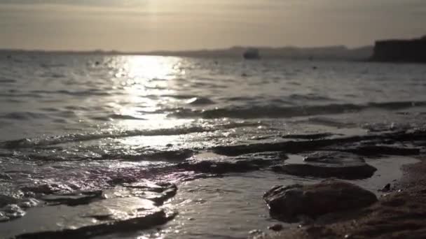 Морський пейзаж зі скелястим берегом на заході сонця в повільному русі — стокове відео