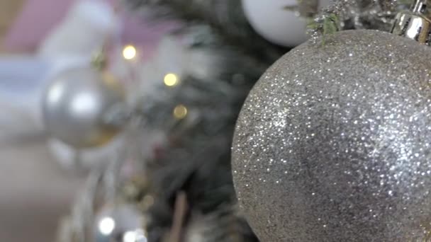 A newborn baby is lying on the sofa near the Christmas tree. Slow motion. — Stock Video