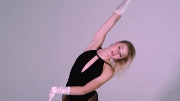 Красивая блондинка танцует в студии, одетая в сексуальное черное белье и перчатки — стоковое видео