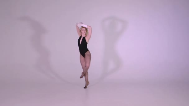 Красивая сексуальная девушка с хорошей растяжкой танцует в студии в замедленной съемке — стоковое видео