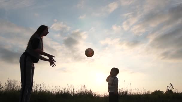 Två år gammal pojke spelar bollen som volleybollspelare vid solnedgången i slow motion — Stockvideo