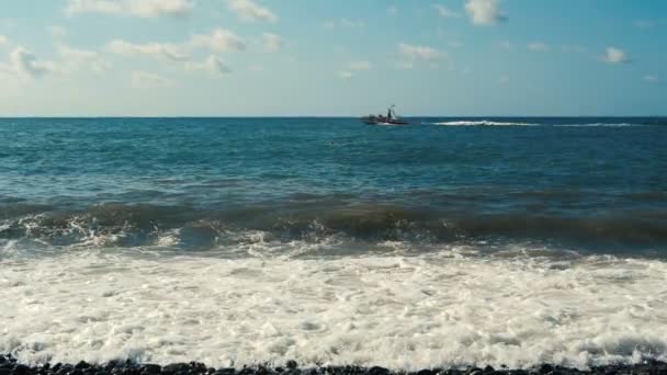 Small powerboat floating along the Black Sea beach in summer in slo-mo — Stock Video