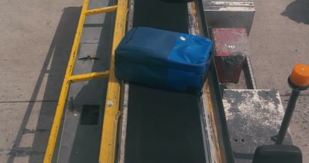 One blue suitcase moving on a conveyor at a customs office in Georgia in slo-mo — Stock Video