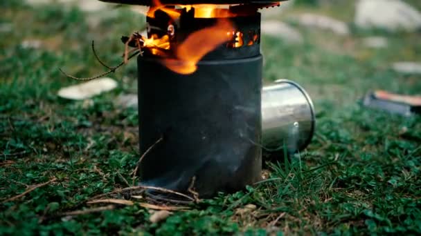 Bright fire over a black stove outdoors in slow motion. — Stock Video