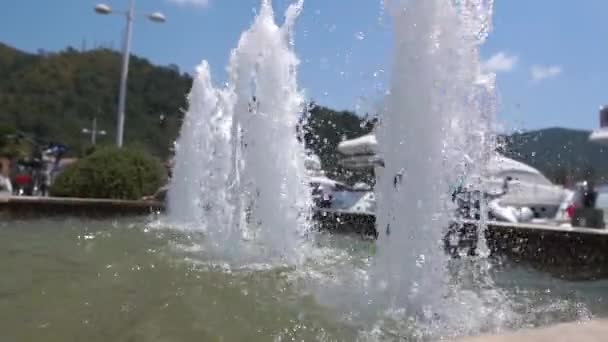 Beautiful fountain on the pier in slow motion on a sunny summer day — Stock Video