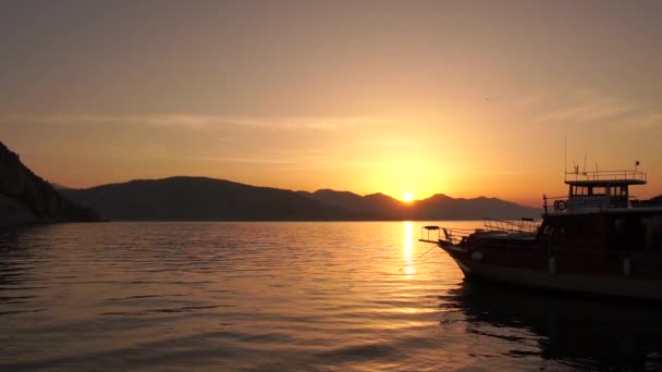 Beautiful seascape with a ship during a golden sunset in slow motion — Stock Video