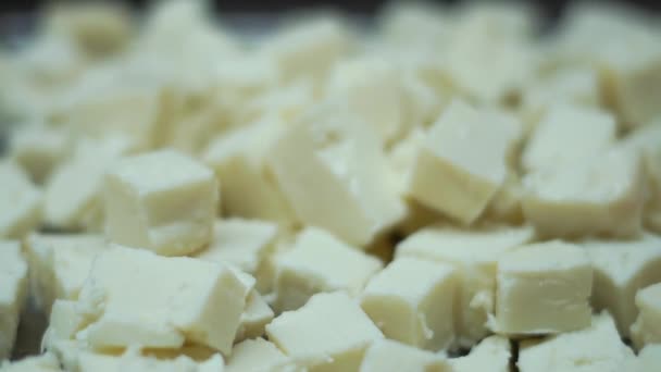 Large slices of cheese in a bowl on a buffet in slow motion — Stock Video