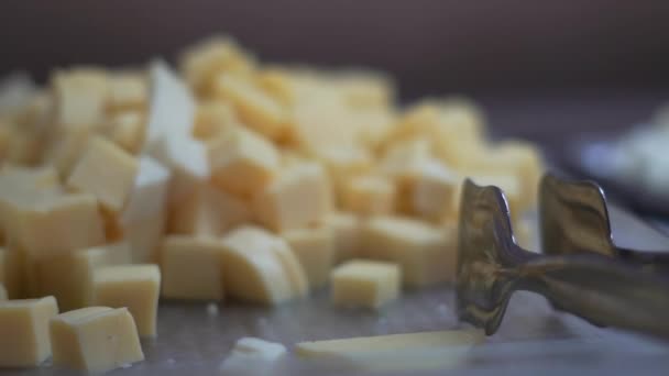 Large slices of cheese in a bowl on a buffet in slow motion — Stock Video