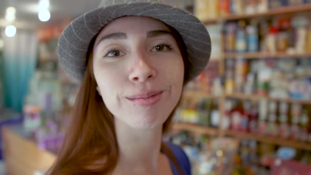 Beautiful brown hair girl giving an air kiss inside of a shop in slow motion — Stock Video