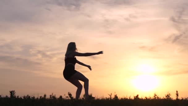 Silueta sexy dívka skáče a ohýbá se ve skoku ve zpomaleném filmu — Stock video