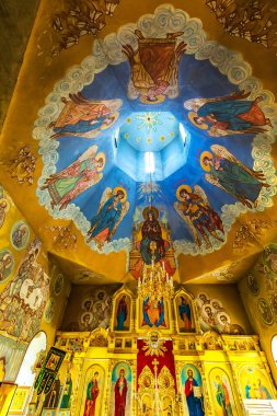 The village of Chingisy, Novosibirsk oblast, Western Siberia,Russia - July 21, 2018: the Orthodox Church of the Holy apostles Peter and Paul. Painting of the temple walls clipart