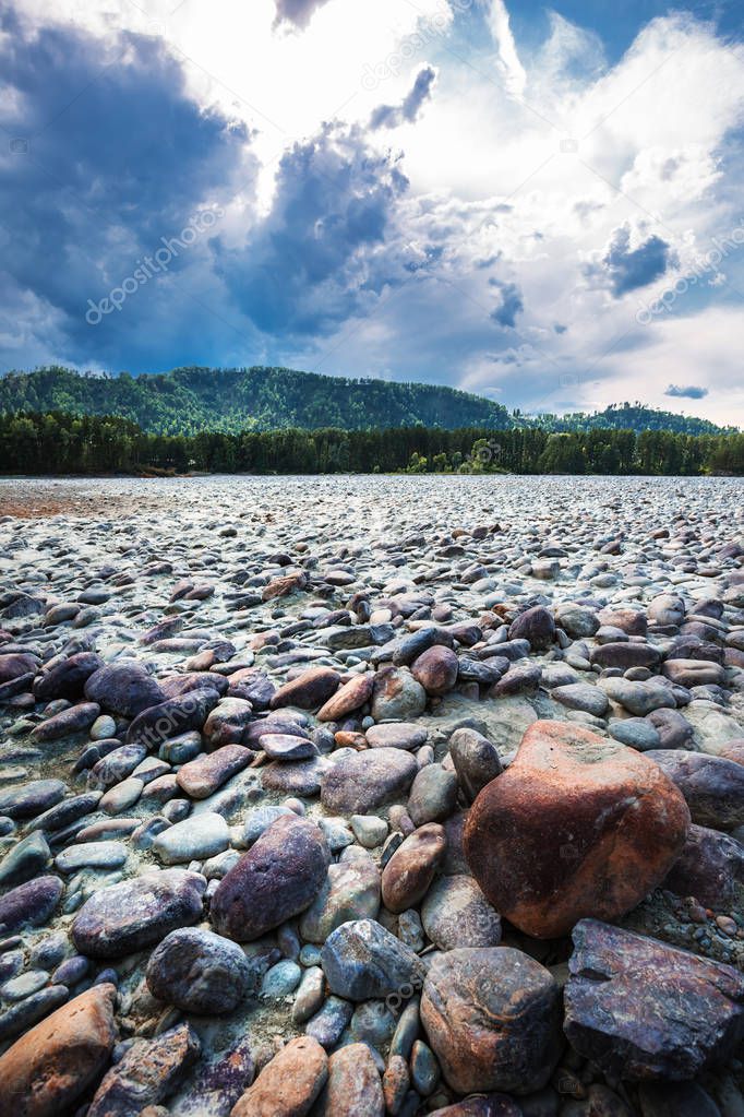 The coast of the river Katun with bared rounded stones. Mountain Altai, Southern Siberia, Russia