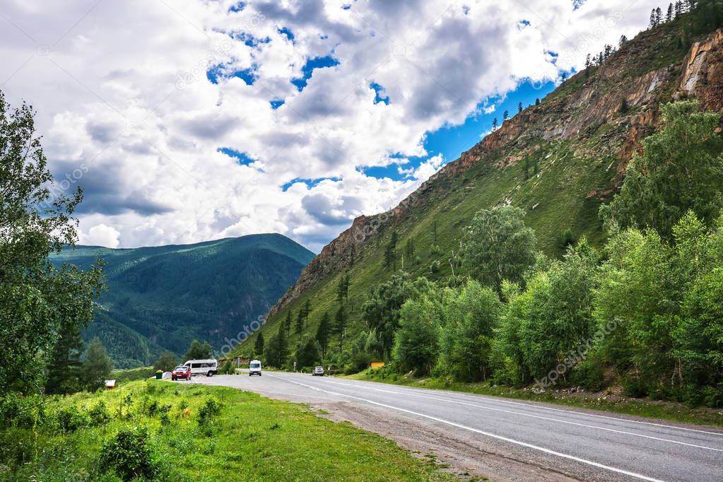 Car Chuyskiy trakt surrounded by mountains. Altai Republic, Russ