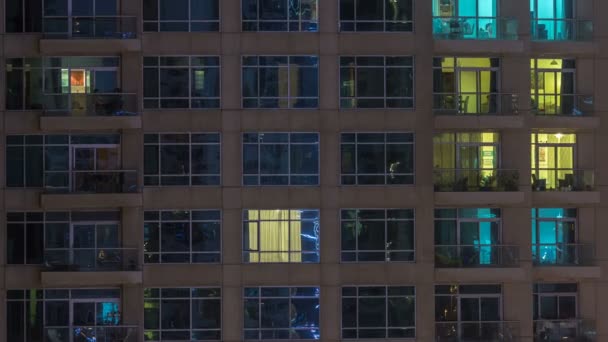 A többszintes épület, az üveg és acél, belső világítás, és mozgó emberek timelapse Windows — Stock videók
