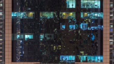 Windows çok katlı binanın içinde aydınlatma ve insanlar timelapse içinde hareketli çelik ve cam