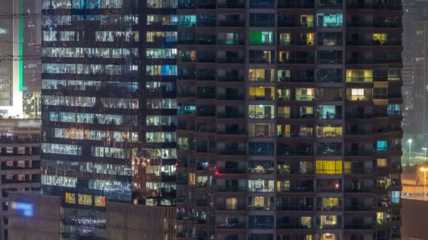 Ventanas del edificio de varios pisos de iluminación de vidrio y acero en el interior y personas en movimiento dentro de timelapse — Vídeo de stock