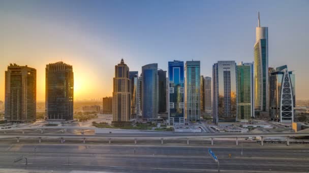 Aerial view of Jumeirah lakes towers skyscrapers at sunrise timelapse with traffic on sheikh zayed road. — Stock Video
