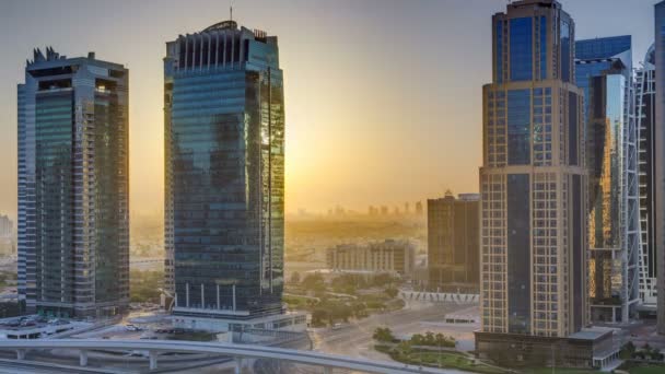 Luchtfoto van Jumeirah lakes towers wolkenkrabbers bij zonsopgang timelapse met verkeer aan sheikh zayed road. — Stockvideo