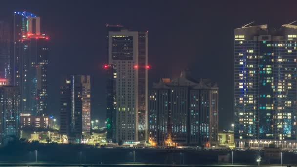 Buildings on Al Reem island in Abu Dhabi night timelapse from above. — Stock Video