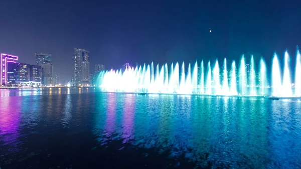 Evening Musical fountain show. Singing fountains in Sharjah timelapse, UAE 4K