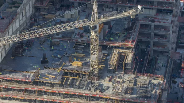 Construction cranes at Dubai Marina timelapse. Building of skyscrapers. Aerial top view with many workers