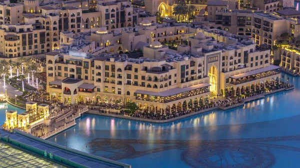 Dubai downtown day to night transition timelapse with fountain, bridge and mall. Top view from above after sunset