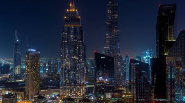 En yüksek bina ve Sheikh Zayed karayolu trafik, Birleşik Arap Emirlikleri Dubai şehir manzarası gece timelapse. Işıklı modern kuleli gökdelenin çatı üzerinden havadan görünümü