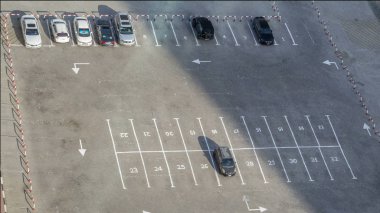 Park yerinde timelapse sarı, beyaz, siyah, gri, gümüş, mavi, diğeri gibi renkli araç çeşitleri ile gökdelenin çatı üzerinden en iyi görünümü. Arabalar değişiklikleri, gölgeler hızlı taşır. Dubai, Birleşik Arap Emirlikleri