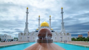 Nur Astana Camii dış ön plan timelapse hyperlapse Astana, Kazakistan'ın Çeşmede ile. Caminin en büyük ikinci Kazakistan'da yer alır. Yaz günü bulutlu gökyüzü