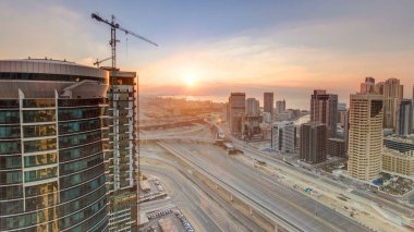 Dubai, Birleşik Arap Emirlikleri Dubai Yat Limanı ve Jlt gökdelenler, güzel günbatımı hava üstten görünüm timelapse. Modern kuleleri ve Şeyh zayed yolu üzerinde trafik 