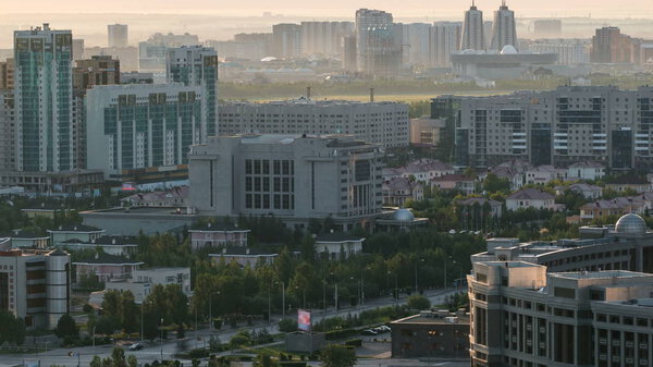 Elevated morning view over the city center and central business district Timelapse at sunrise time with mist, Kazakhstan, Astana, Central Asia 4K