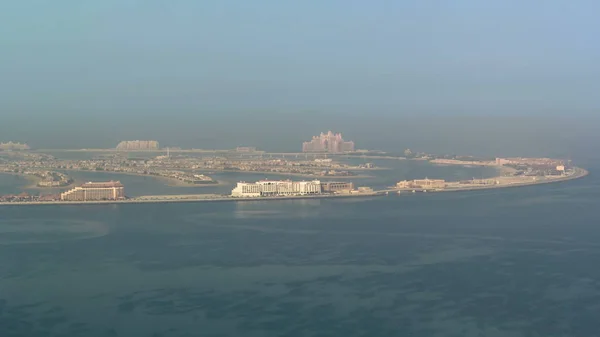 Foggy view on artificial island Palm Jumeirah from Burj Al Arab at morning in Dubai, UAE. It is one of three islands called the Palm Islands at Dubai`s coastline. timelapse 4K
