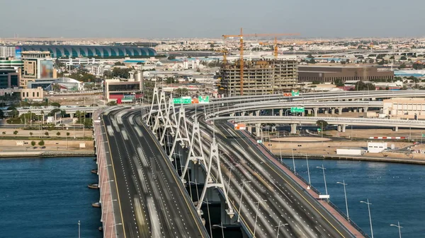 Business bay crossing bridge timelapse, 13-lane-bridge, over the Dubai Creek, opened in March 2007. Blue cloudy sky before sunset