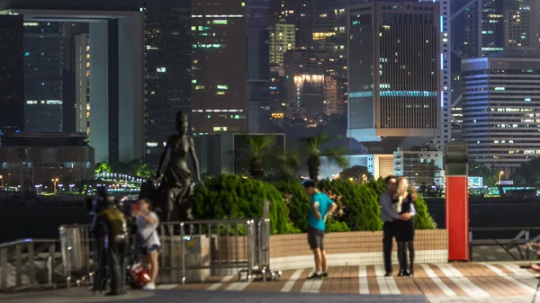 Statue and skyline in Avenue of Stars timelapse at night with city skyline in Hong Kong, China.  The promenade honours celebrities of the Hong Kong film industry as the famous city attraction. 4K