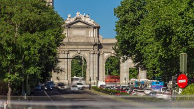 The Puerta de Alcala  timelapse (Alcala Gate) with traffic is a Neo-classical monument in the Plaza de la Independencia (Independence Square) in Madrid, Spain. View from Plaza de Cibeles clipart