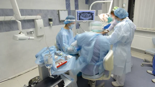 Dentists during surgery for implant placement timelapse. Stock Image