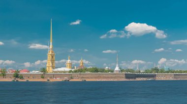 Peter and Paul Fortress across the Neva river timelapse, St. Petersburg, Russia. Blue cloudy sky clipart