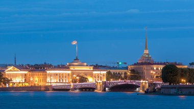 Quay of river Neva with illuminated building of Admiralty and Palace bridge timelapse at wthite night. St. Petersburg, Russia. Reflection in water clipart