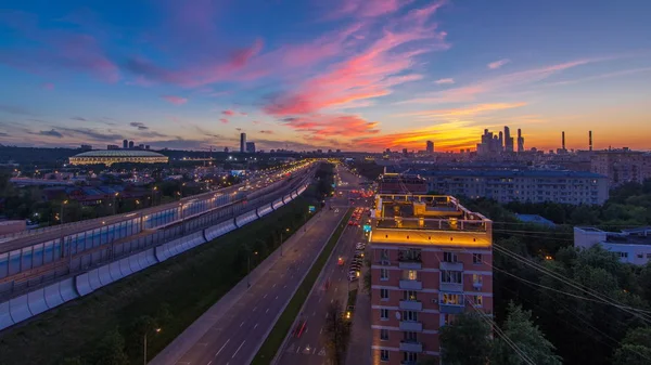 The Third Ring Road traffic after sunset day to night transition timelapse aerial view from rooftop. Skyscrapers and stadium on background. The Third Ring is Moscow's newest beltway, located between the Garden Ring in the city centre and Moscow Ring