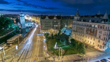 Sitkovska water-tower night timelapse (circa 1588) and traffic on road in old city center of Prague. World Heritage Site of UNESCO. View from top of dancing house clipart