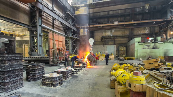 Pouring of liquid metal in open hearth workshop timelapse hyperlapse. Factory workshop with steelmaking furnace