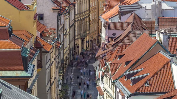 Top view from the height Powder Tower in Prague timelapse to Old Town with people the street and red roofs. Historical and cultural monument. Prague, Czech Republic.