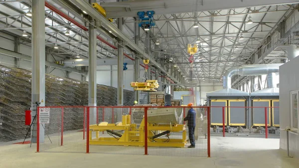 The operator lifting device timelapse, lift loads using lifting magnet, mechanical workshop, concrete and metal structures plant. Reinforced concrete Factory modern workshop