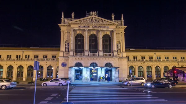 People on the Tomislav Square in front of Main Railway Station night timelapse hyperlapse, main hub of Croatian Railways network. Traffic on the road. ZAGREB, CROATIA