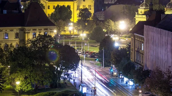 Panorama of the city center night timelapse shoot from top of the skyscraper with a view to the intersection in front of national theater and museum in Zagreb, Croatia. Traffic on the road