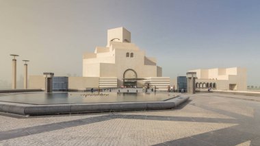 Doha, Katar - Jan 2018 yaklaşık: Katar'ın İslami Sanatlar Müzesi timelapse hyperlapse dhows onu çevreleyen koyda demirlemiş ile Doha Corniche, yanında insan yapımı, adada. Çeşme ile önden görünüm