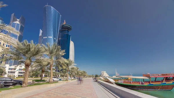 Walk on Doha\'s Corniche in West Bay timelapse hyperlapse with modern skyscrapers, Qatar. The Corniche is a popular exercise location known for fantastic promenades, water sports, traditional dhow races and more