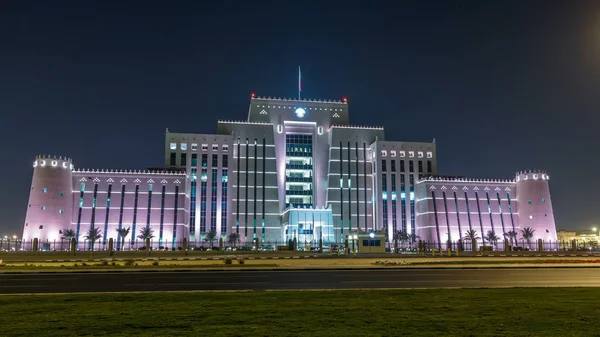 The Ministry of Interior in Doha night timelapse. View from park. Traffic on the road. Doha, Qatar, Middle East